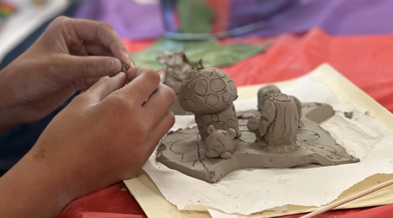 A child creating a clay model