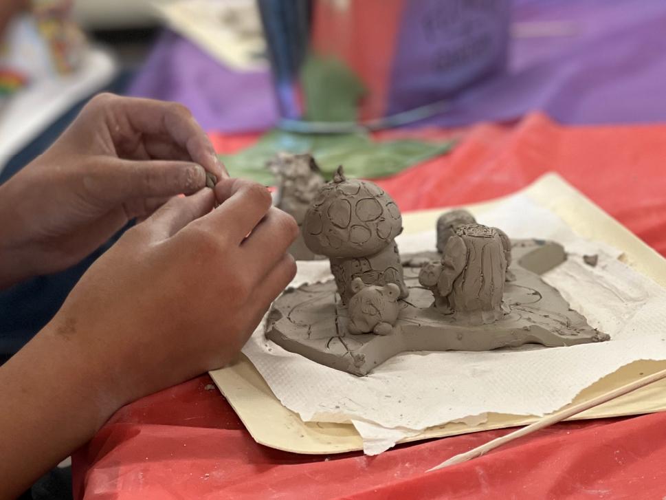 A child creating a clay model